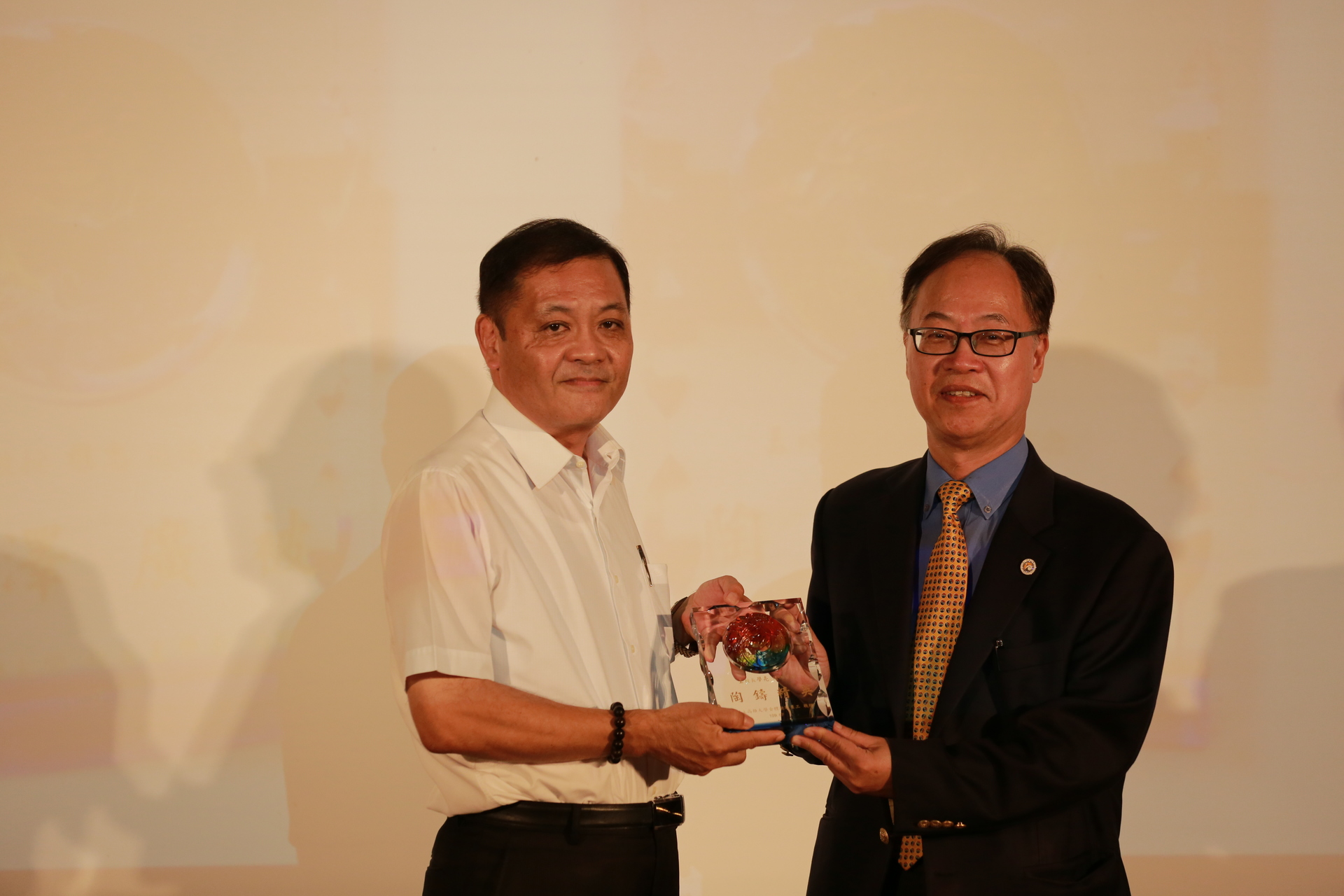 學術副校長莊寳鵰（左）頒贈校長王學亮榮退紀念品。